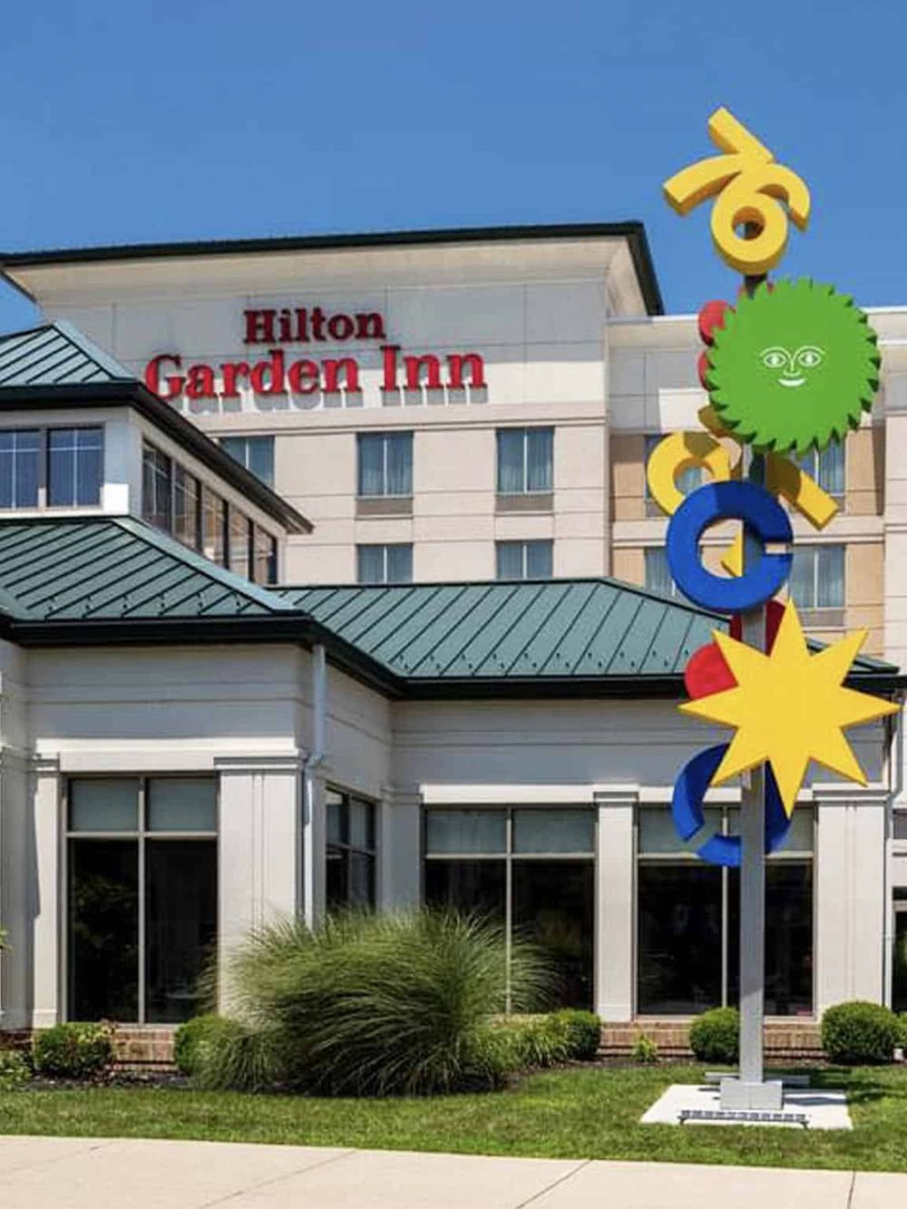 Colorful Google-themed sculpture outside Hilton Garden Inn hotel in QuestForDirections location.