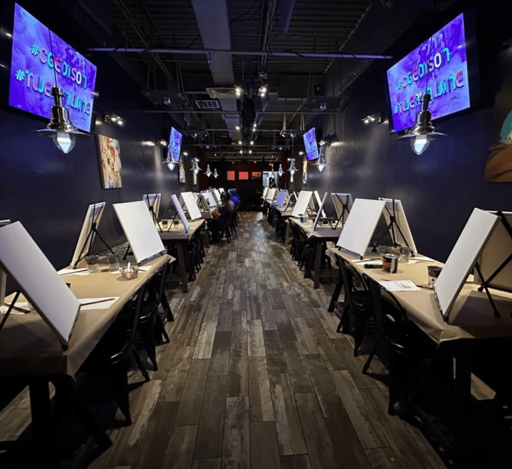 1. Modern indoor painting studio with individual easels and creative workspace.