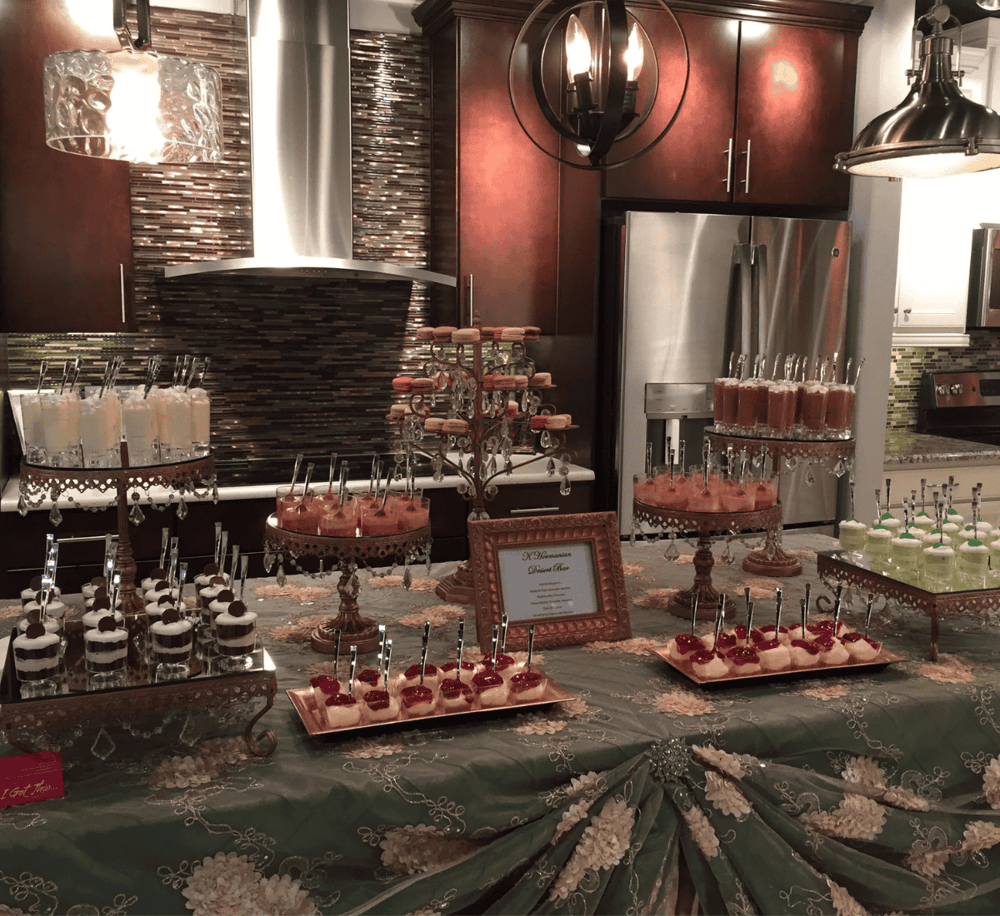 Elegant dessert table with assorted sweets and drinks at a catered event.