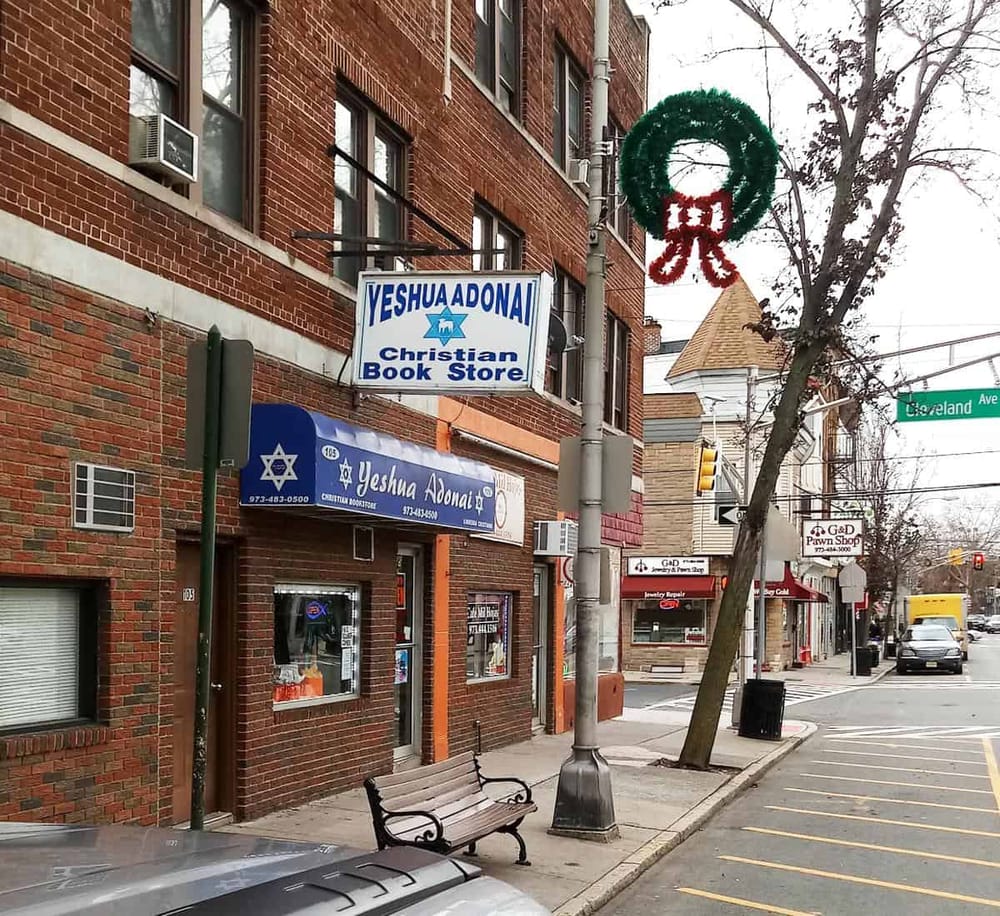 Veshu Adonai Christian Book Store on a city street decorated for Christmas.