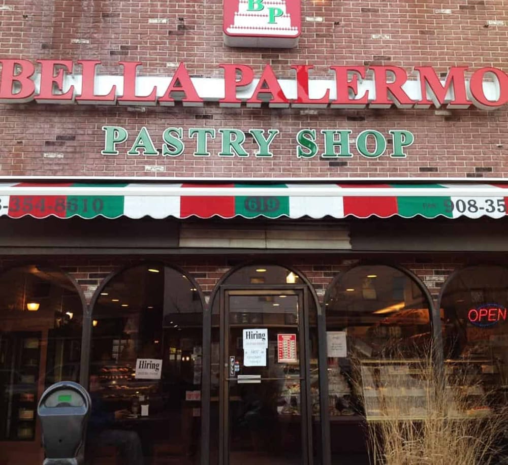 Cozy bakery storefront for Bella Palermo pastry shop with outdoor signs and hiring notices.