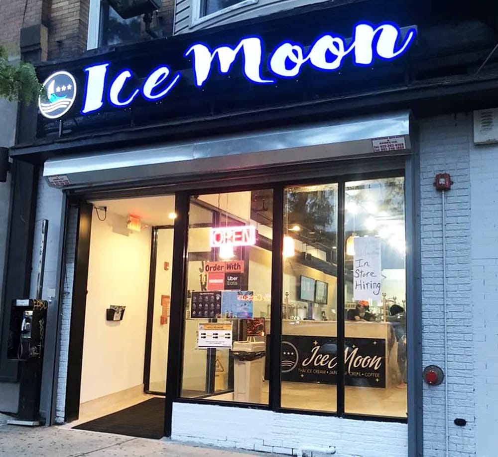 Neon "Ice Moon" ice cream shop exterior with open sign and hiring notice, ideal for neighborhood dessert locations.