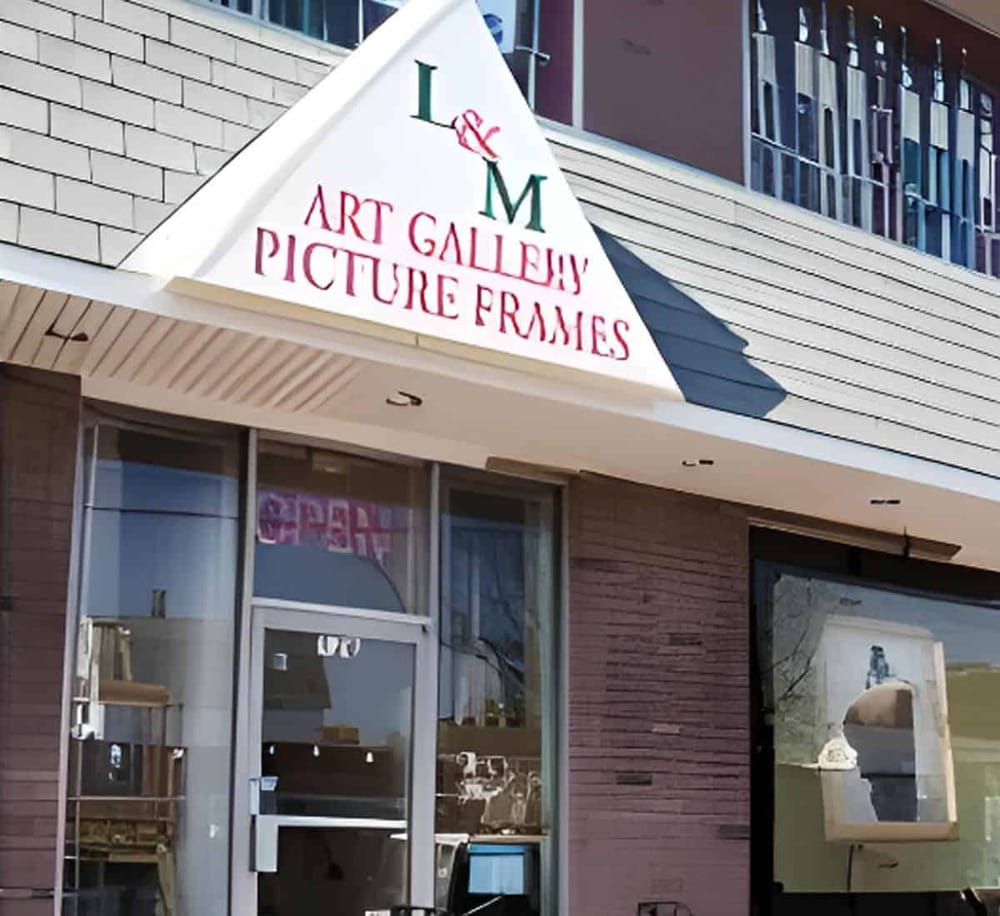 Colorful art gallery with picture frames exterior signage, modern building facade, vibrant storefront.