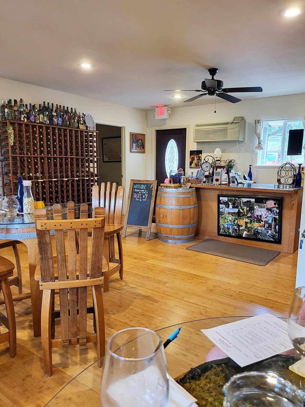 Cozy restaurant interior with wine display and wooden furniture, ideal for dining and exploring local taste at QuestForDirections.