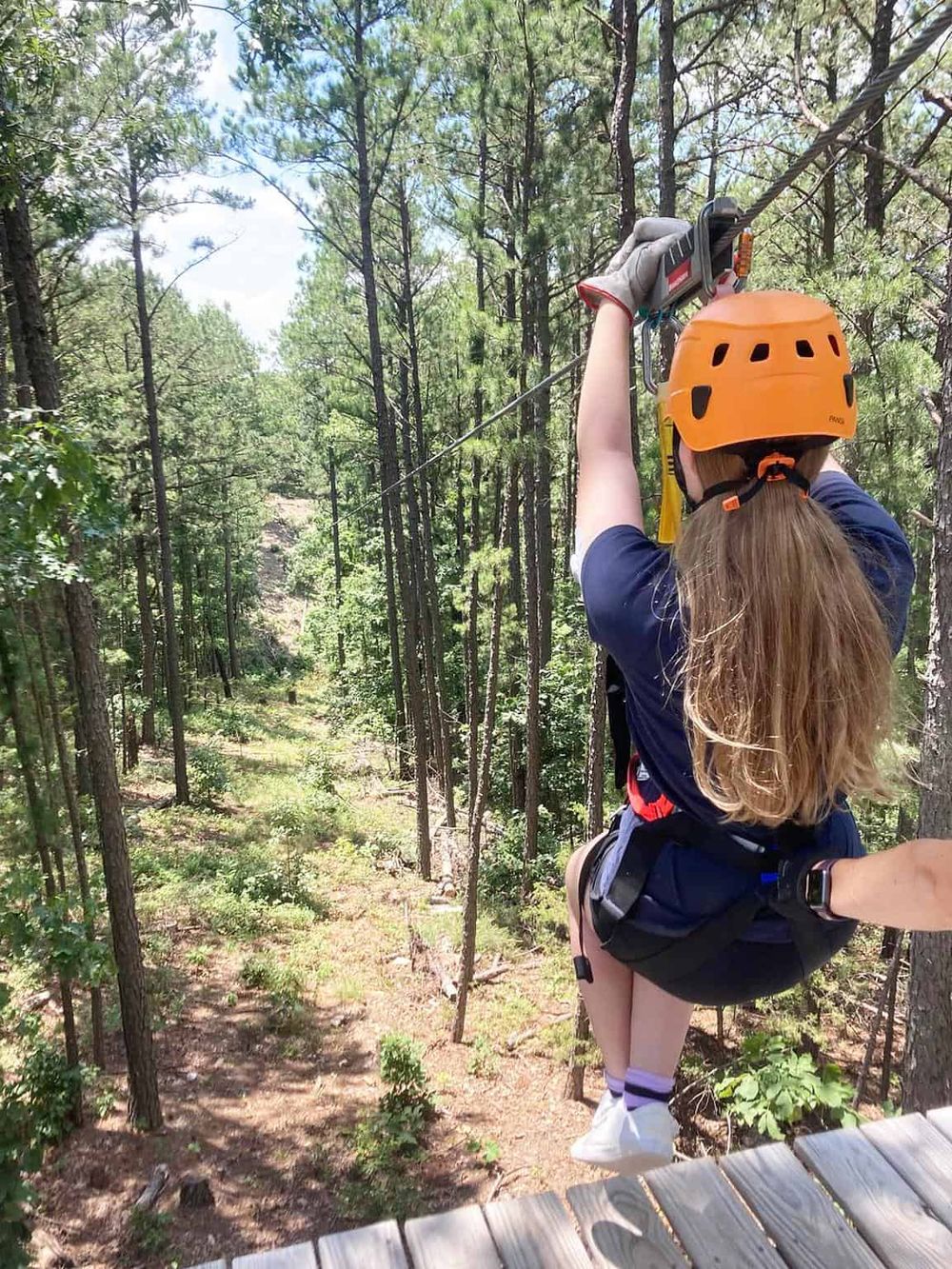 Thrilling ropes course adventure amidst lush forest canopy for outdoor adventure enthusiasts.