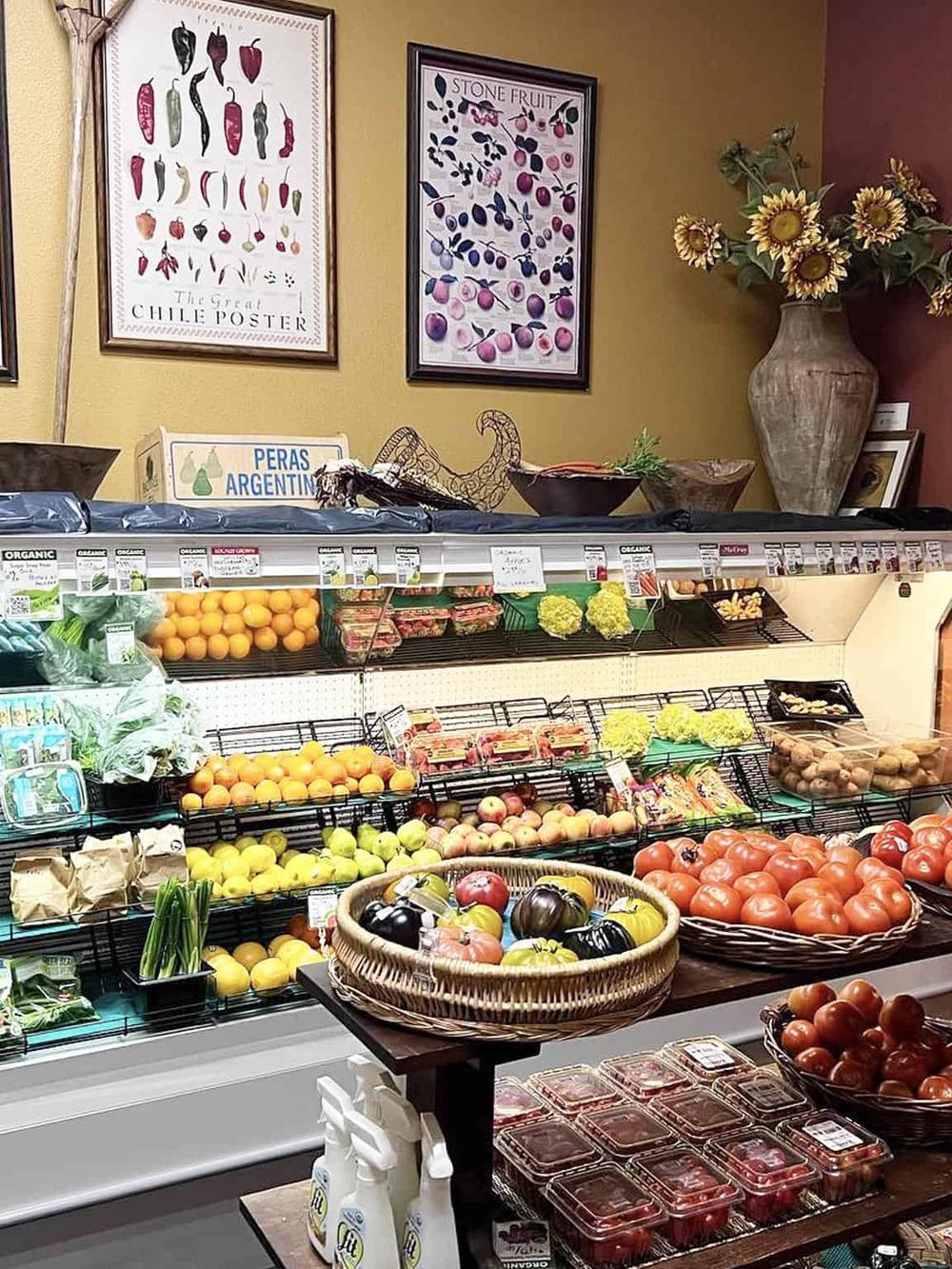 Fresh organic produce and colorful vegetables in a grocery store aisle.