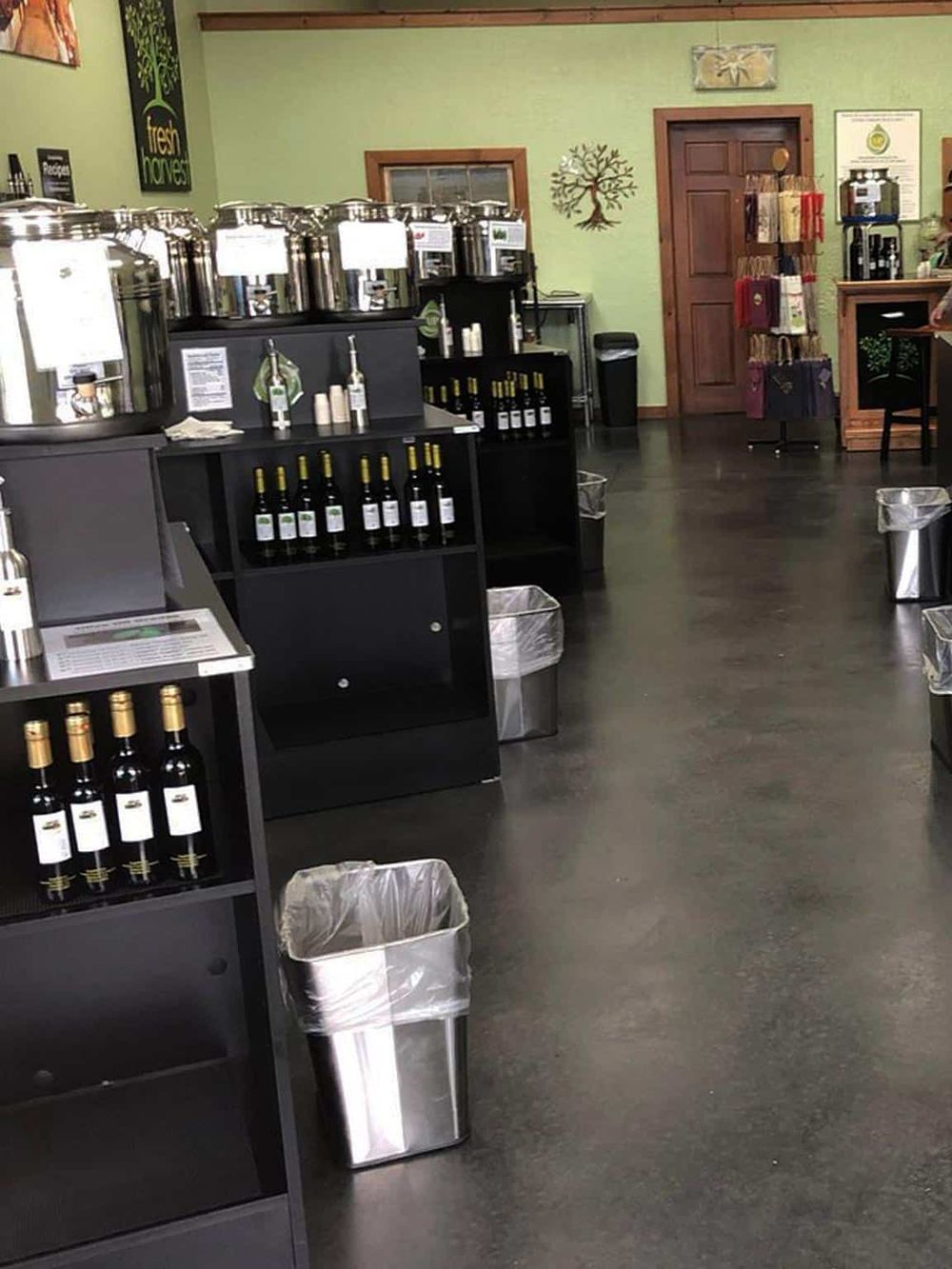 Fresh olive oil and vinegar dispensers in a specialty food shop.