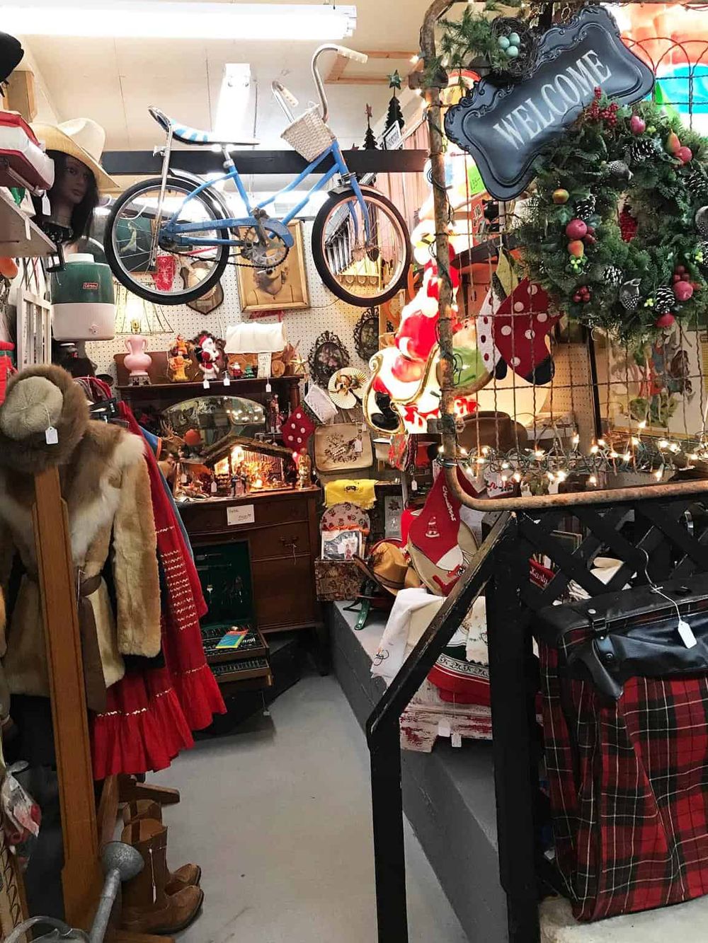 Vintage Christmas thrift store with holiday decor, ornaments, and vintage items on display.