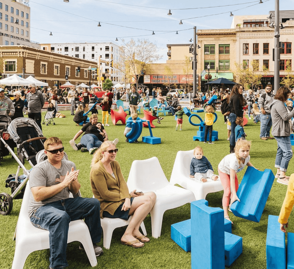 Playing outdoor toys at family-friendly community event in downtown area.