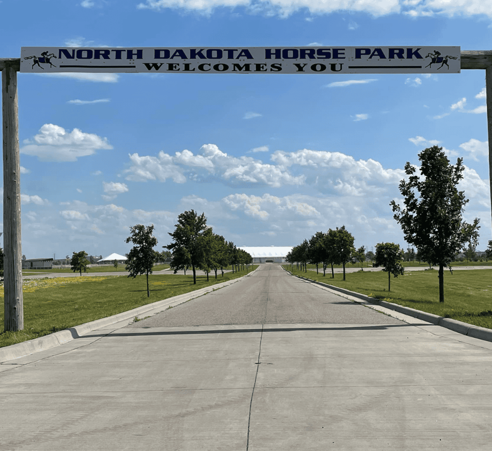 North Dakota Horse Park entrance sign, open outdoor equestrian venue, scenic rural landscape, event destination, QuestForDirections.