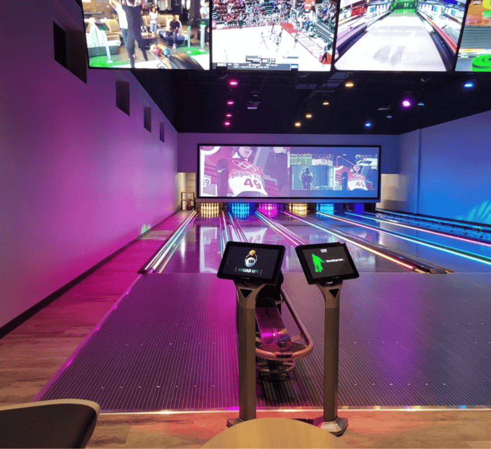 Bright modern bowling alley with digital scoring screens and vibrant lighting, ideal for entertainment and group fun.