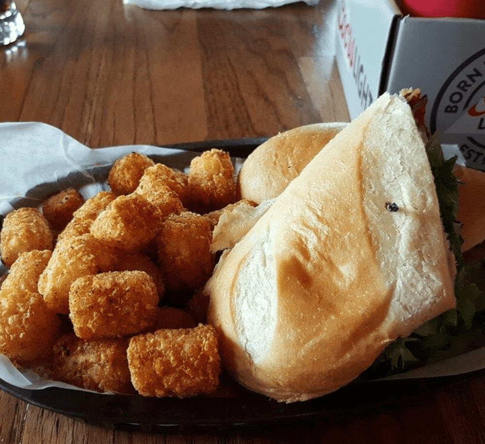 Crispy chicken nuggets with a toasted sandwich on a wooden table at QuestForDirections dining.