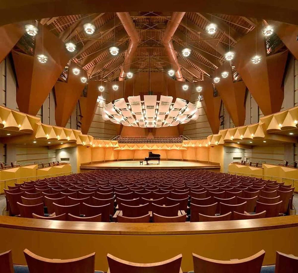 Luxurious concert hall interior with grand piano and elegant lighting, perfect for musical performances and events.