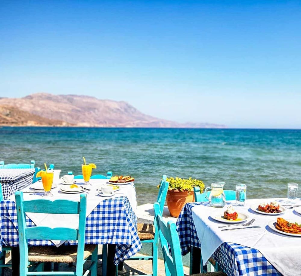 Seafront dining with scenic ocean views and vibrant blue seating at QuestForDirections.