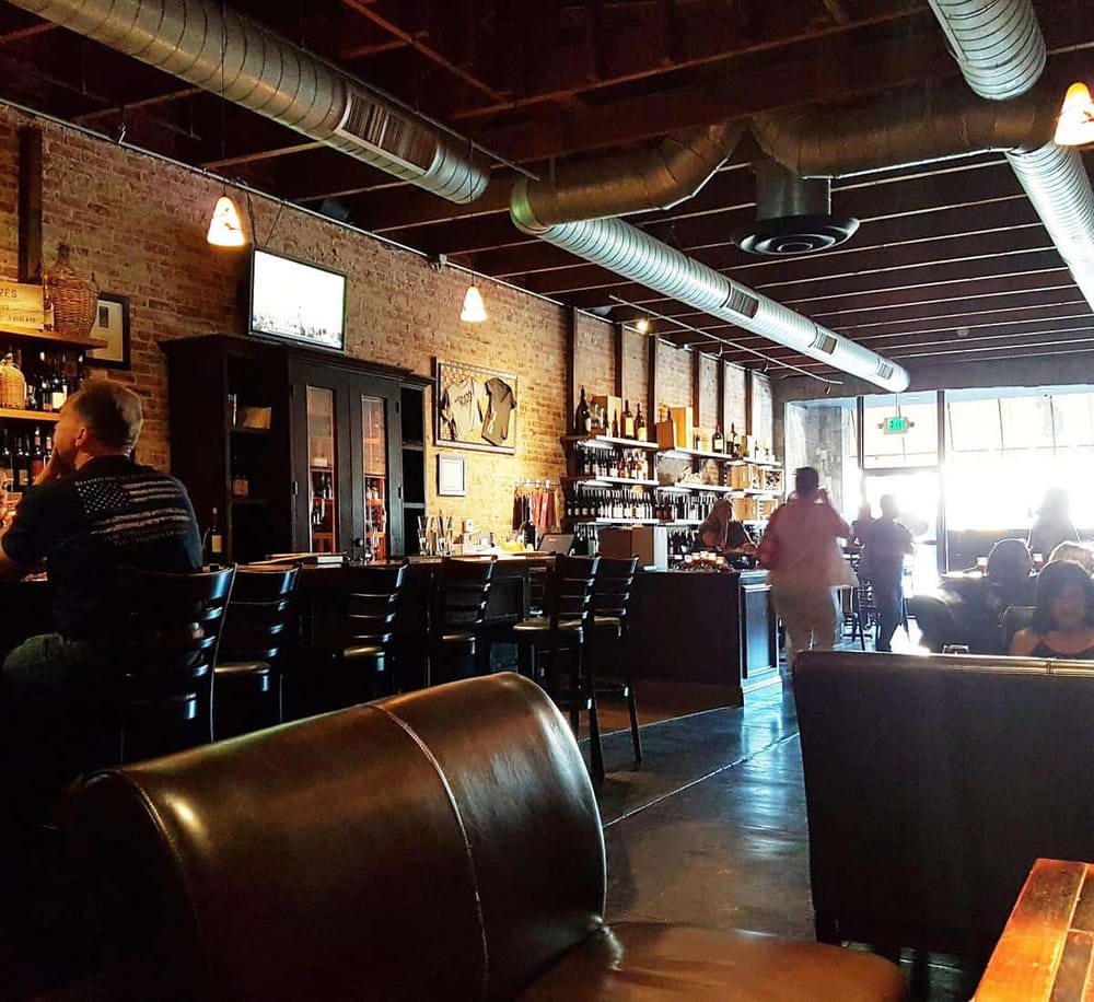 Cozy bar interior in a modern restaurant with exposed brick walls and industrial decor.