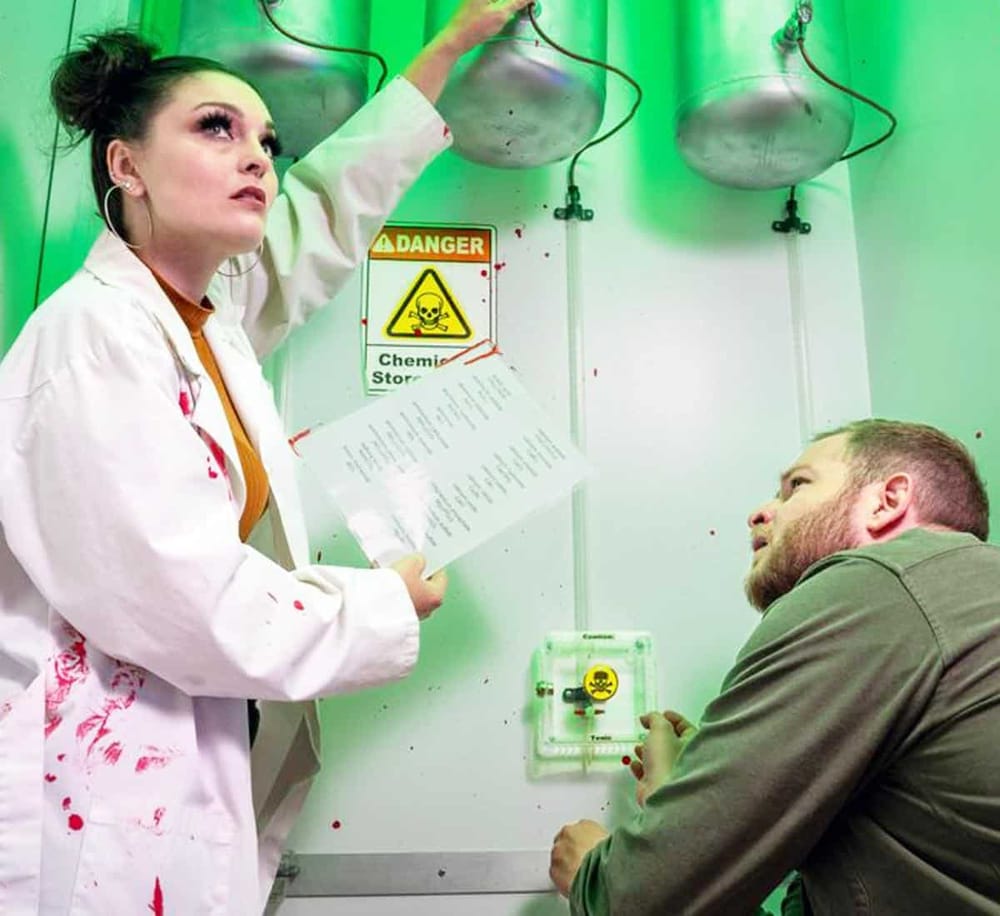 1. Woman in a lab coat with bloodstains in a dangerous chemistry lab setting.