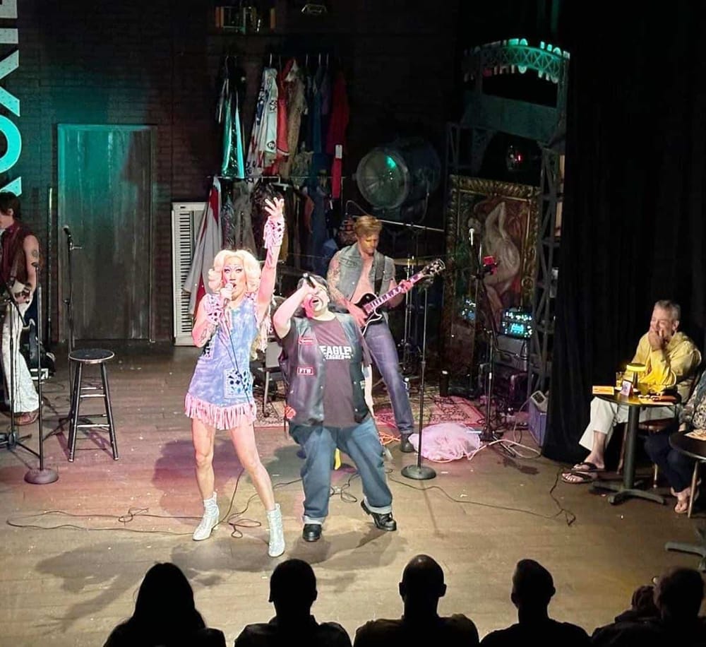 Vintage drag queens performing on stage at QuestForDirections comedy club.