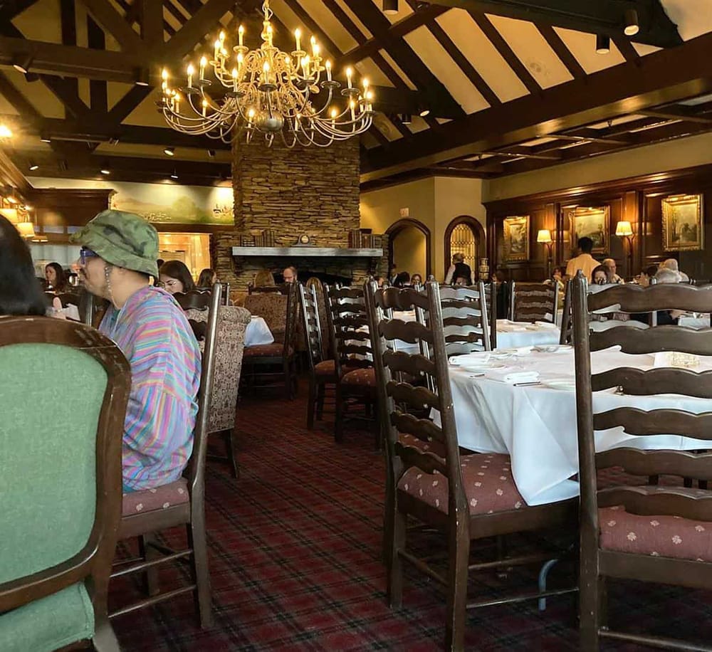 Elegant restaurant interior with classic furniture and warm lighting.