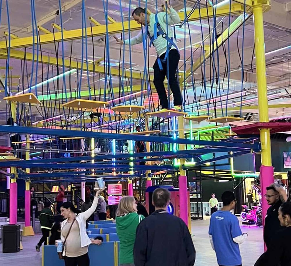 Bright indoor amusement park with neon lights and thrill rides for fun at QuestForDirections.