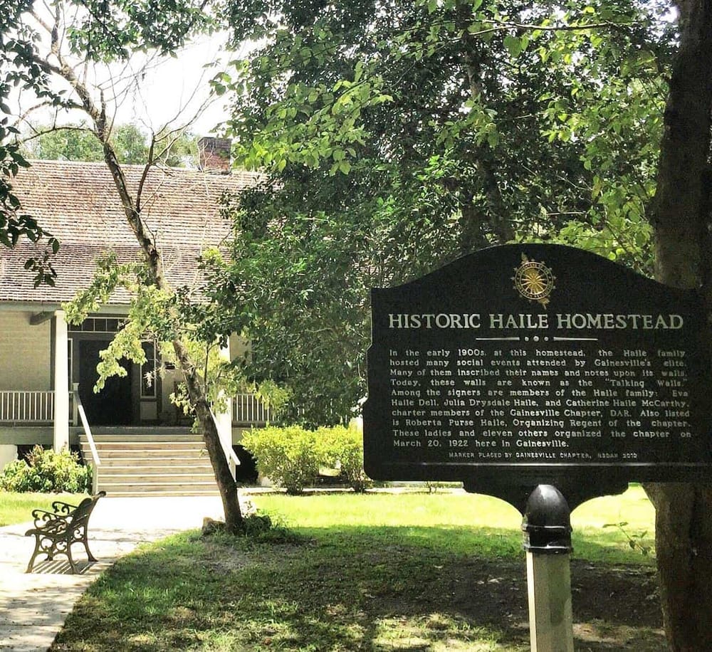 Historic Haile Homestead with old house and informational sign in Gainesville, Florida.