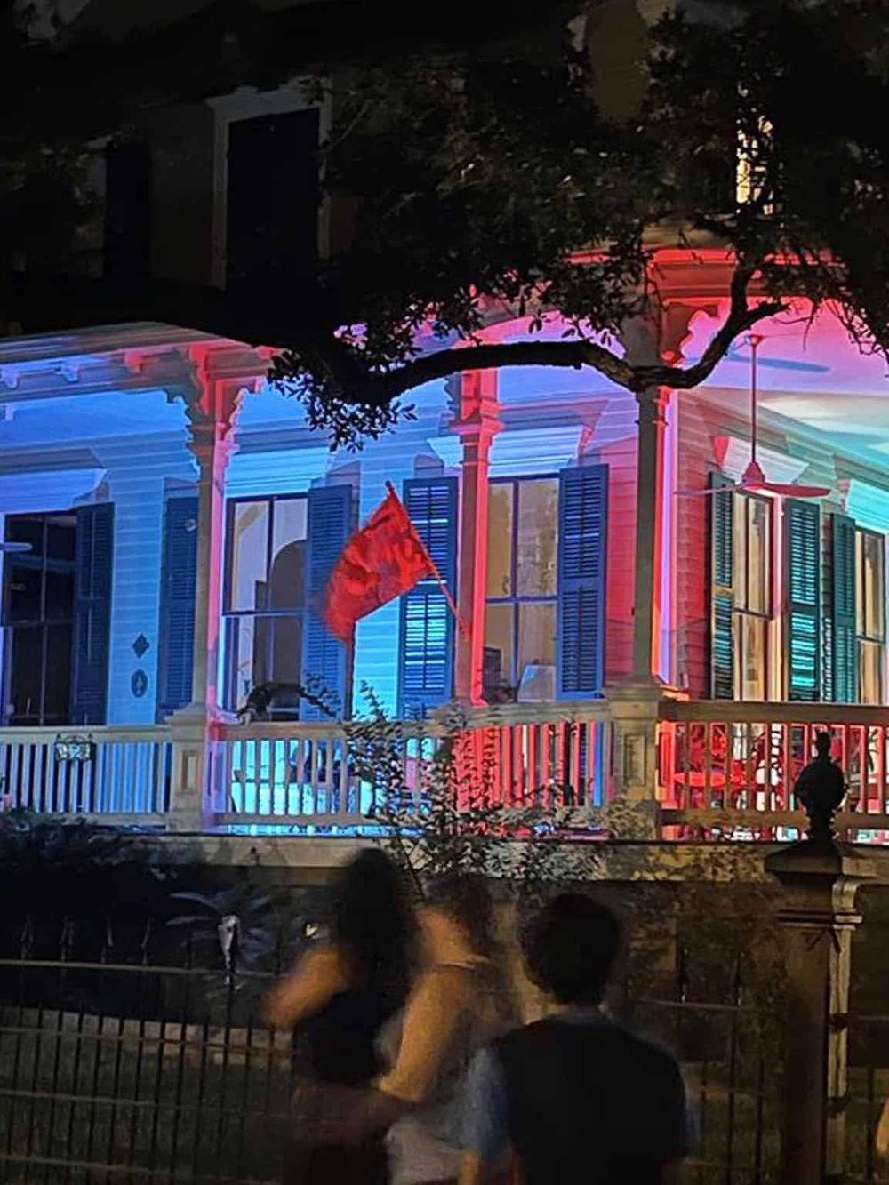 Brightly lit historic house with colorful projection mapping, creating an engaging visual experience.
