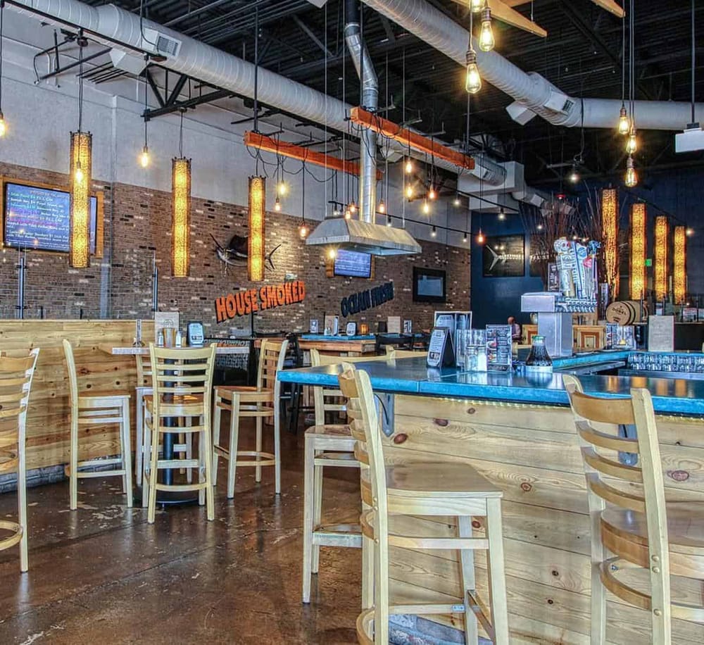 Warm hospitality and craft beer at Quest for Directions brewery bar with rustic decor and ample seating.