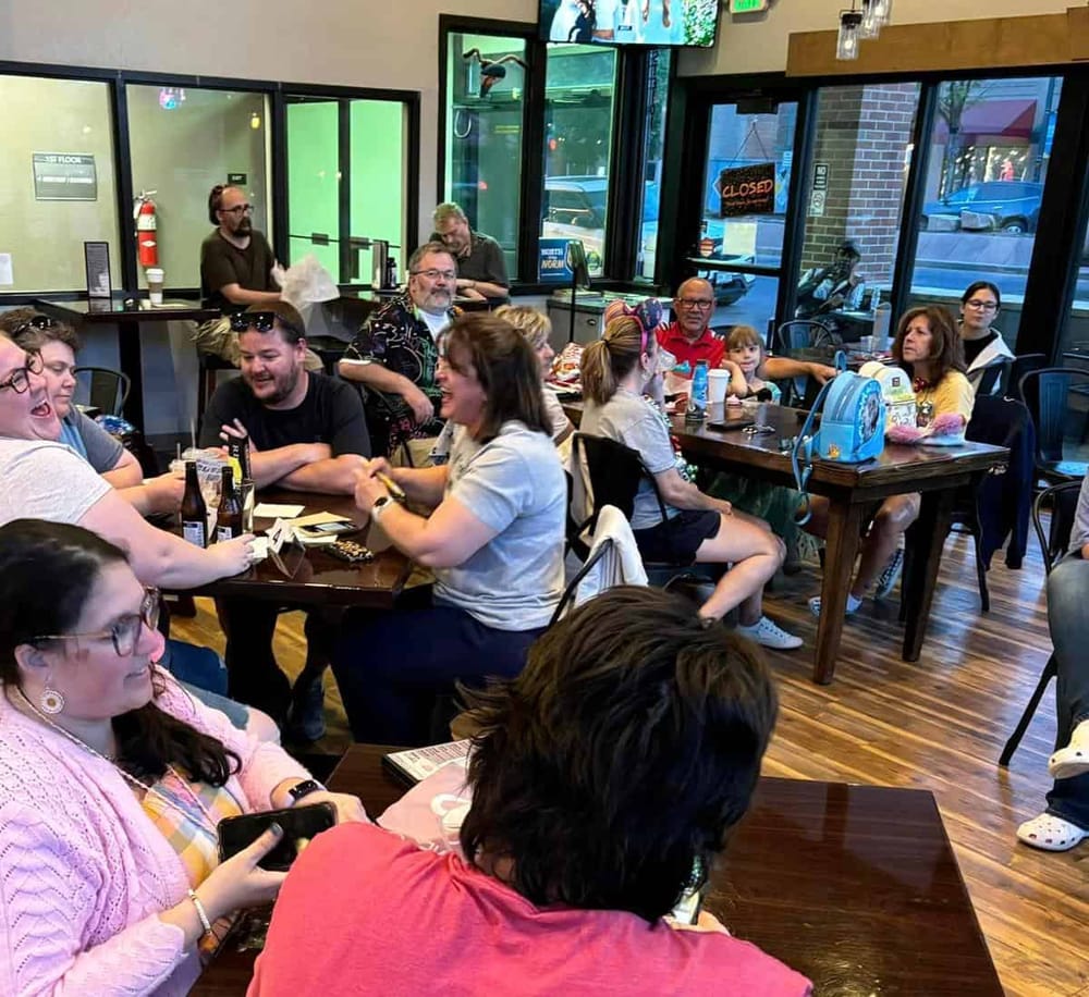 People enjoying and socializing inside a cozy restaurant, vibrant atmosphere, family friendly dining experience, QuestForDirections.