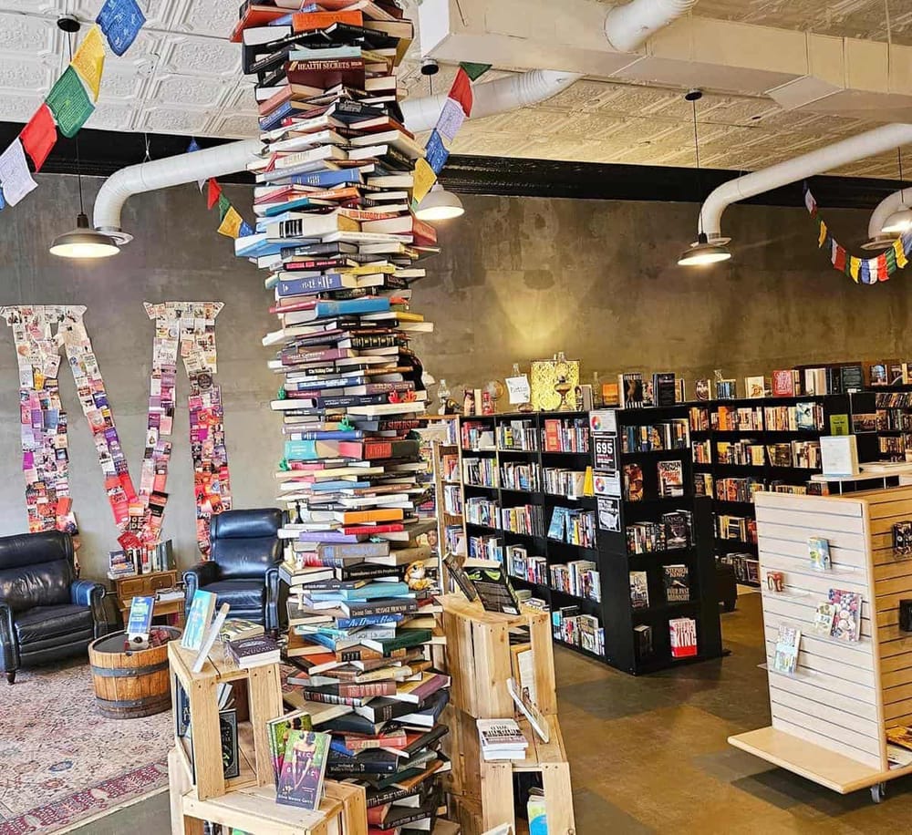 Colorful book sculpture inside a modern bookstore, promoting literature and reading.
