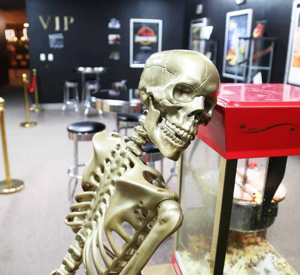 1. Human skeleton model near popcorn machine in a movie theater.