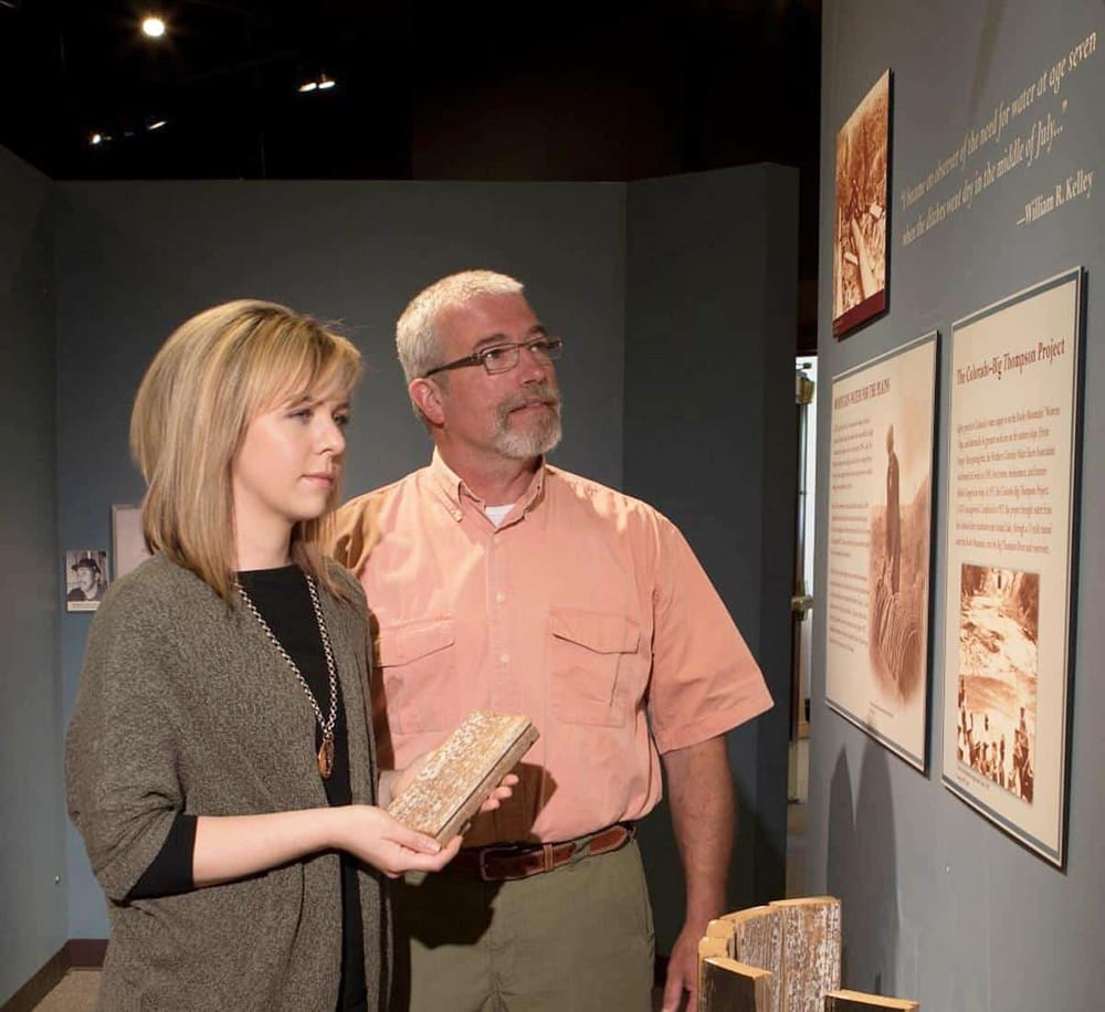 Historical museum visitors exploring educational displays and exhibits.