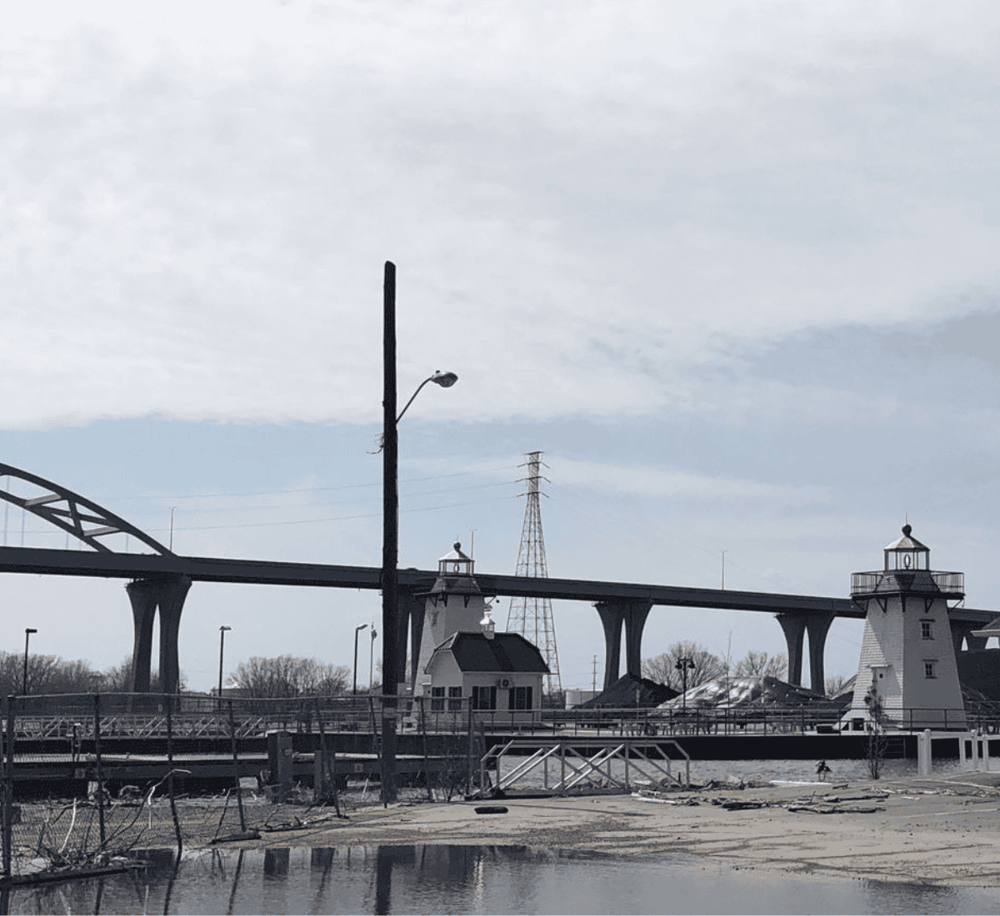 Boat lighthouse structure over water and bridge, scenic harbor view, coastal landmark for navigation and sightseeing.