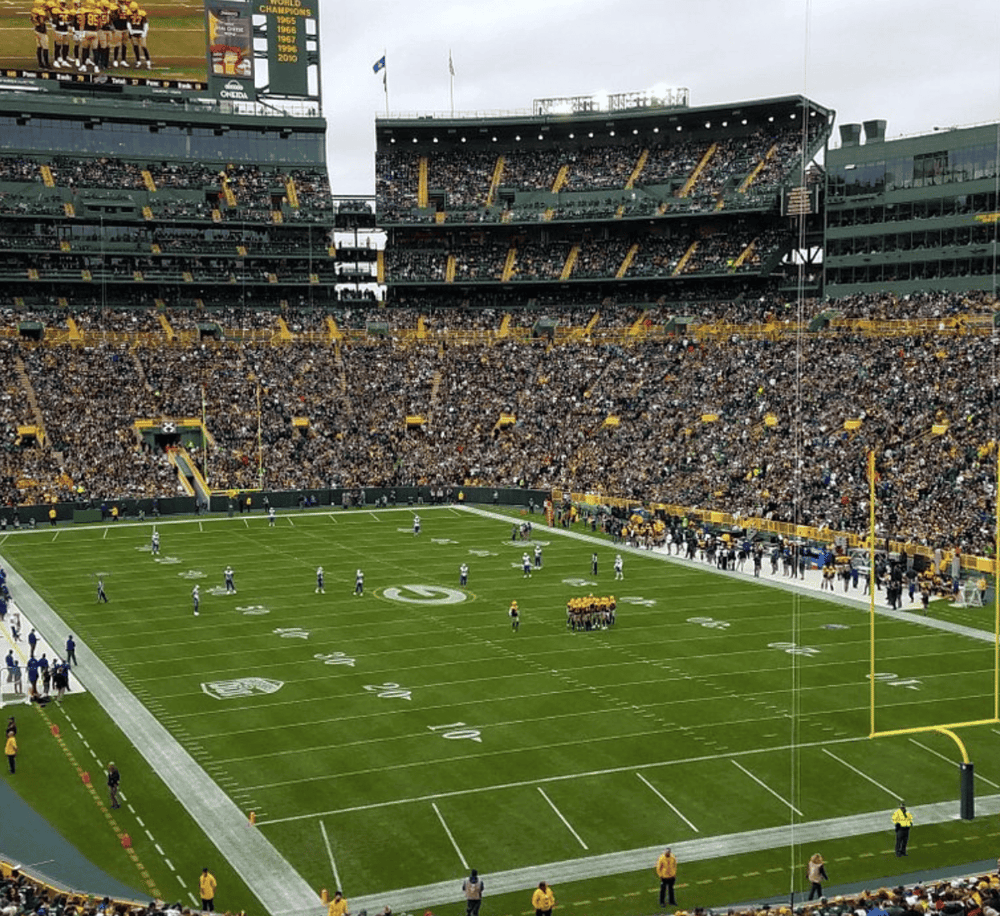 1. NFL football stadium filled with fans during game viewing event.