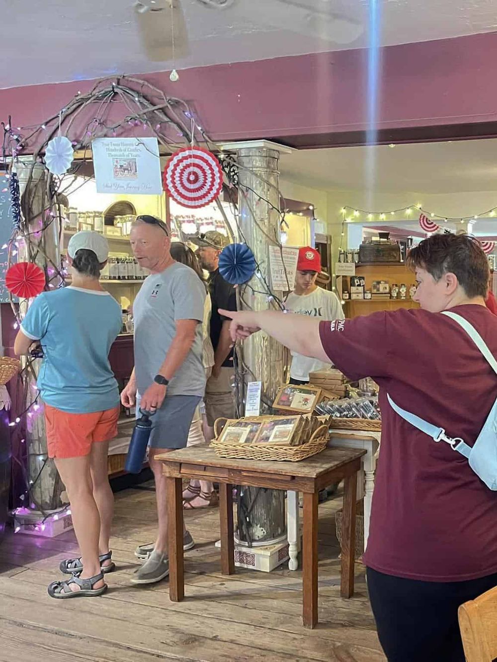Colorful indoor scene at the Quest for Directions store, showcasing friendly staff and a variety of souvenirs and gifts.