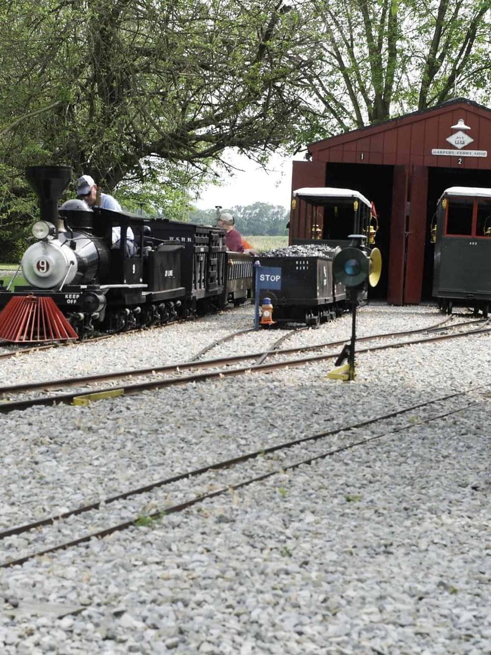 Vintage train ride at Quest for Directions theme park in a scenic outdoor setting.