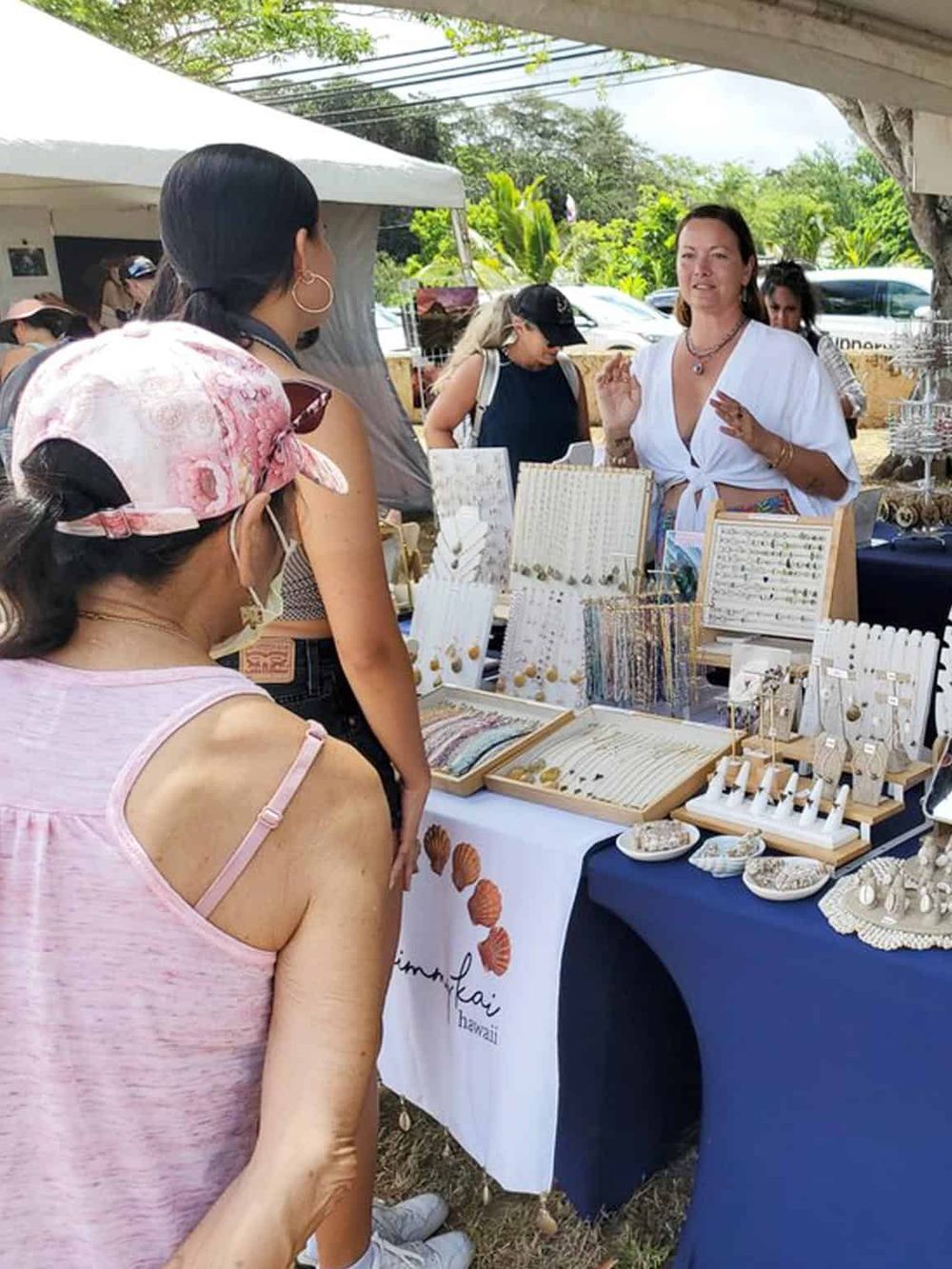 Colorful jewelry display at Hawaii outdoor market scene.