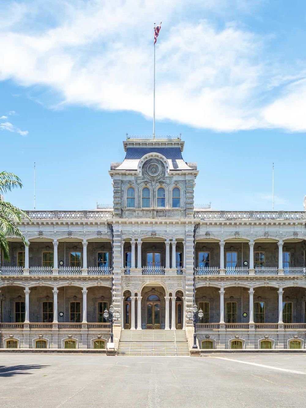 Elegant historic city hall building with detailed stone architecture and flags flying, inspiring government and civic pride.