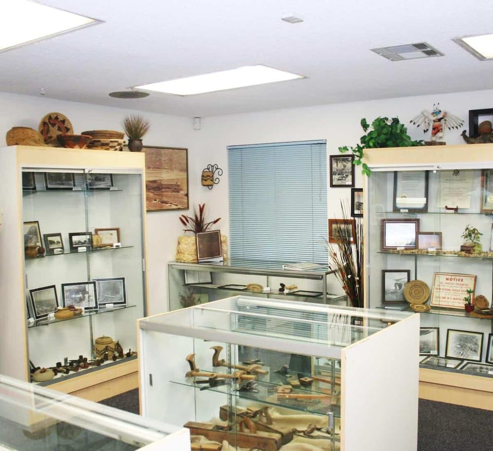 Vintage collectibles and antique artifacts display inside a showroom or museum.