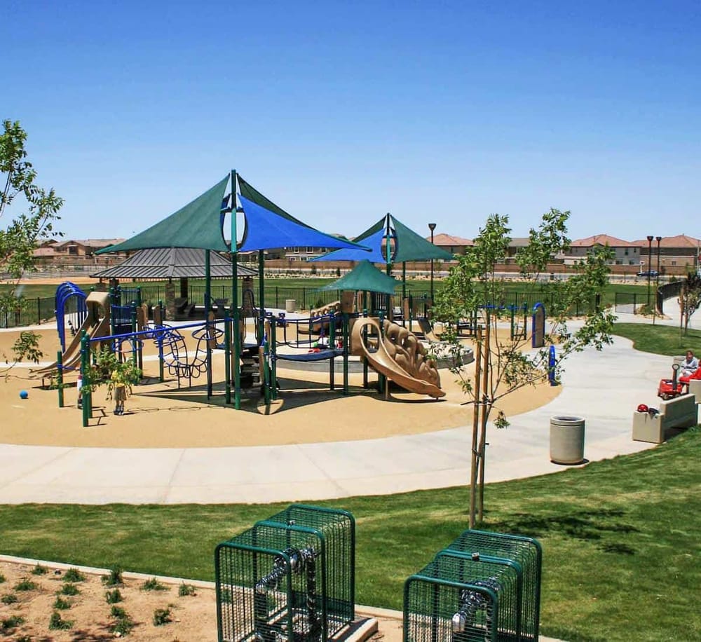 Colorful children’s playground with shade sails in a modern park for family fun and outdoor recreation.