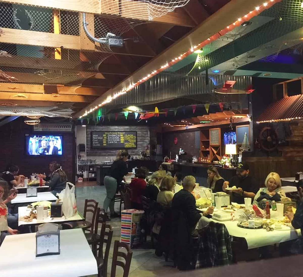 Cozy restaurant interior with group dining and colorful decorations for special events.