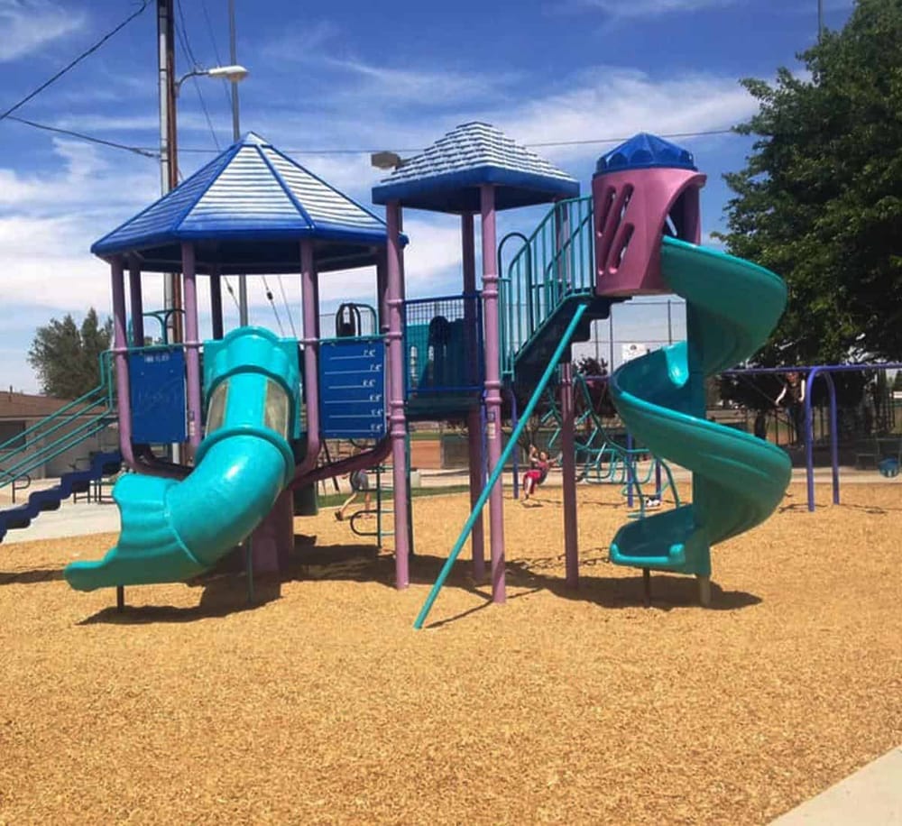 Colorful playground structure with slides and climbing areas at QuestForDirections park.