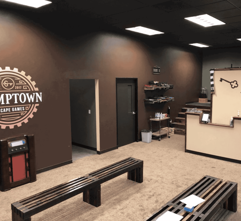 Modern gaming lounge at Quest for Directions with seating, decor, and gaming equipment.