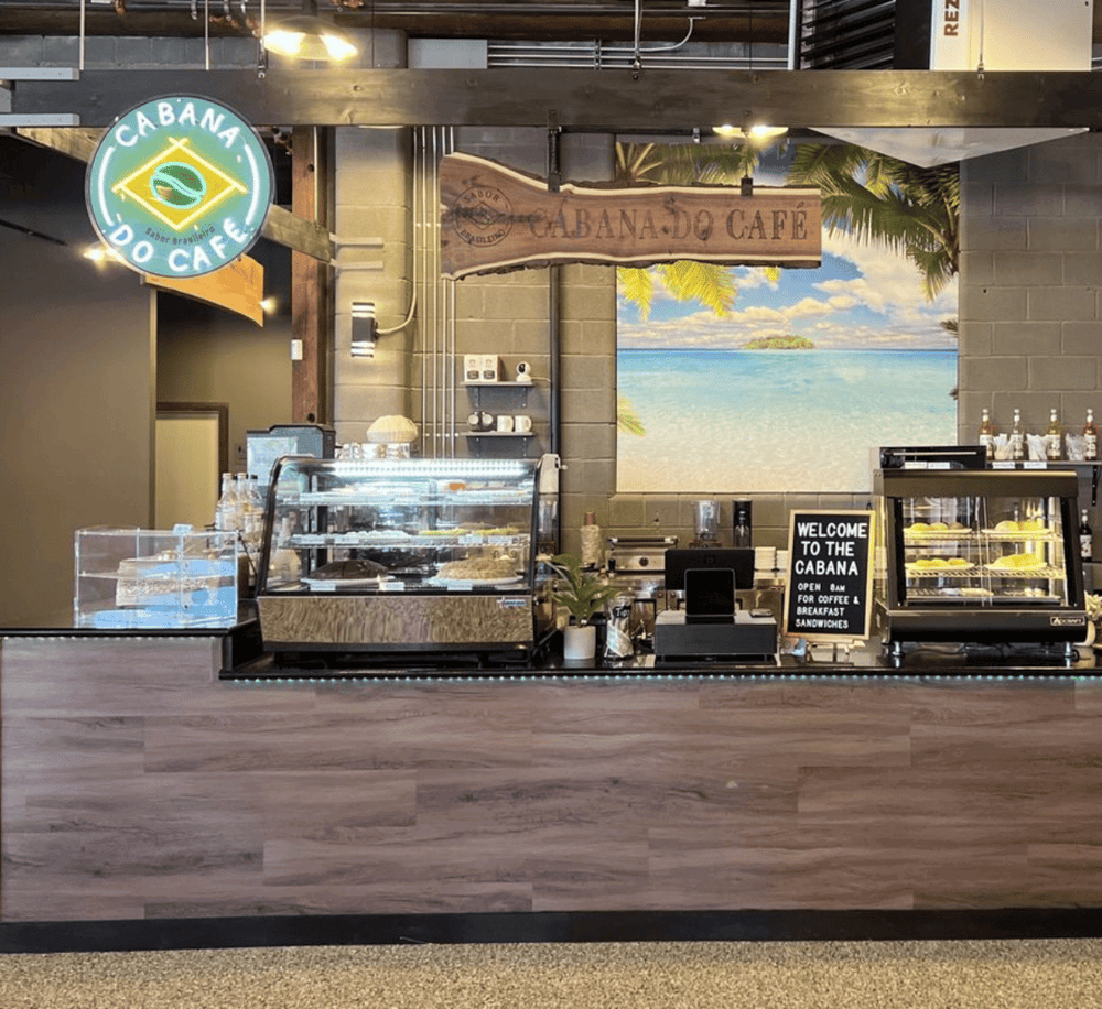 1. Bright interior of Quest for Directions café with beach-themed decor and tropical background.