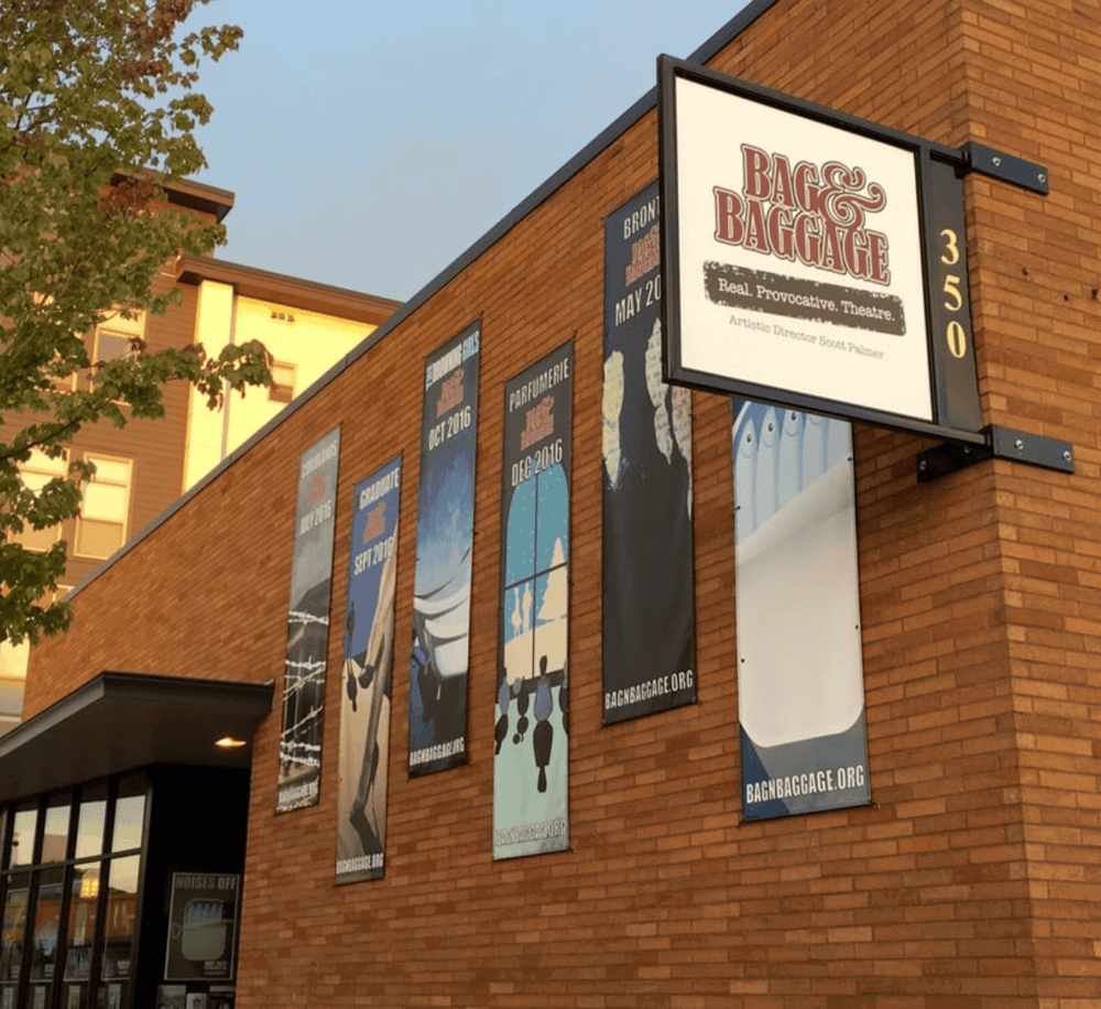 Charming theater marquee for Bagg & Baggage theater, offering provocative plays in a modern brick venue.