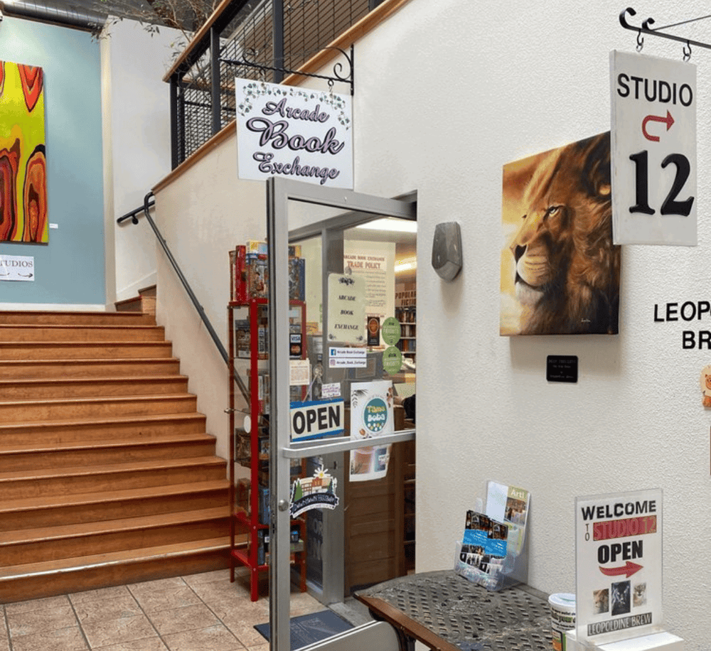 Aromatherapy Book Exchange entrance at QuestForDirections, colorful artwork and signs for community activities.