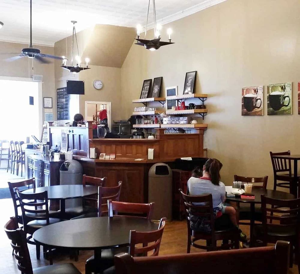 Steamy coffee shop interior with a wooden counter, cozy seating, and family enjoying beverages. Perfect for coffee, breakfast, and casual meetings.
