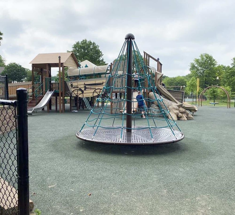 Colorful playground with slides, climbing structures, and swings designed for kids' outdoor fun.