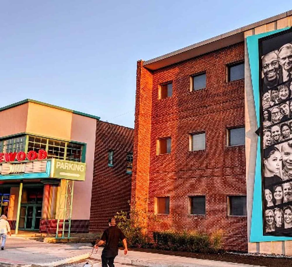 1. Colorful urban building with murals and brick facade, vibrant downtown scene.