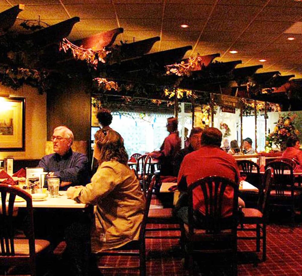 Comfortable restaurant interior with diners enjoying meals, perfect for dining and food experiences.