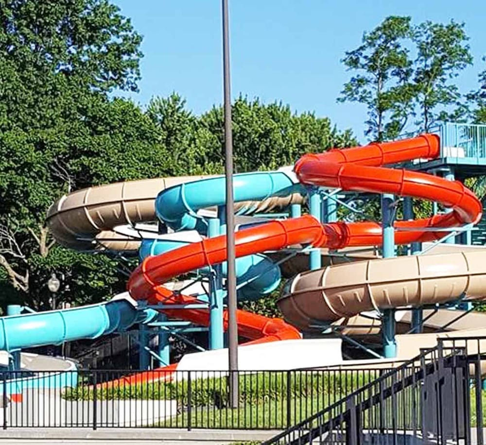 Water park slides at QuestForDirections amusement park, fun family water activities, summer outdoor entertainment.