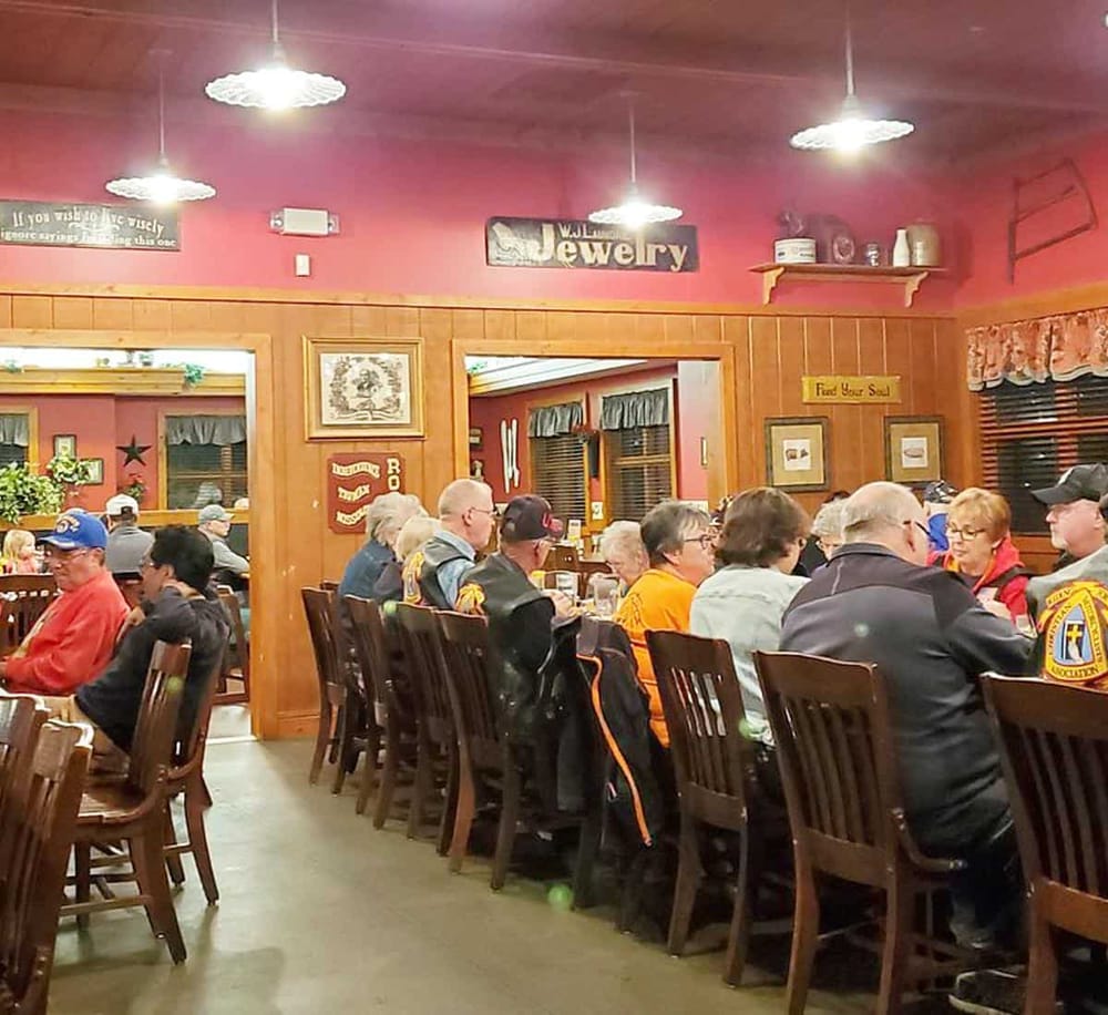 Comfortable indoor dining at a cozy restaurant with diverse guests enjoying food and drinks.